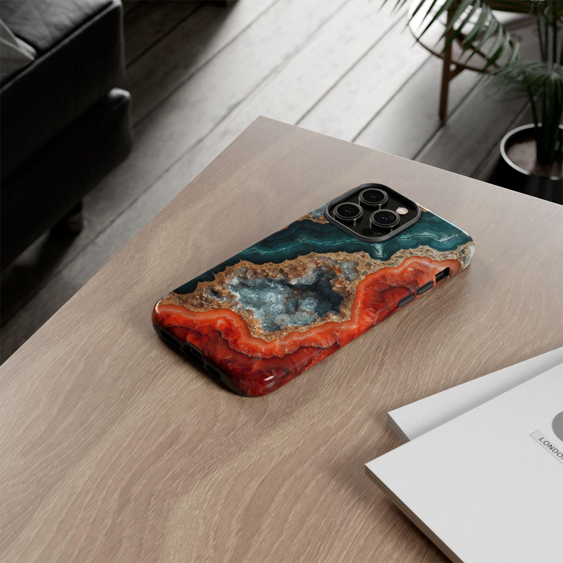 The image is an advertisement for a slim case designed for smartphones. It features a close-up view of the case and a smartphone, highlighting the case's features such as its open access to all ports, impact-resistant corners, raised camera, and screen protection. The case also has a high resolution non-fading print, making it a visually appealing and durable option for smartphone users.
