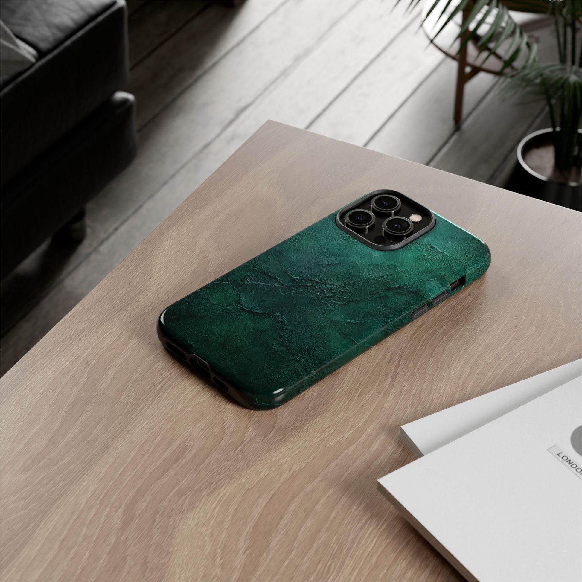 The image is an advertisement for a slim case designed for smartphones. It features a close-up view of the case and a smartphone, highlighting the case's features such as its open access to all ports, impact-resistant corners, raised camera, and screen protection. The case also has a high resolution non-fading print, making it a visually appealing and durable option for smartphone users.